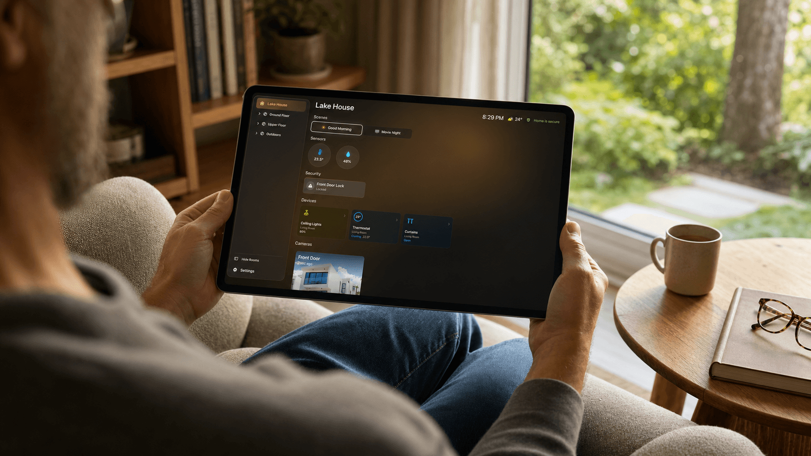 A person using the HomeDeck dashboard on an iPad in a sunlit reading corner